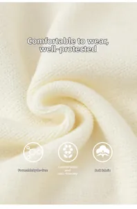 Close-up of soft cream knit fabric texture showing fine stitching and premium warm material