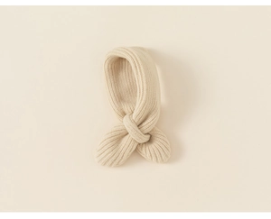 Detail of beige ribbed knit kids scarf showing cozy texture and crossover design