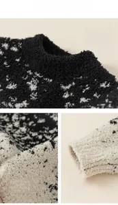 Detail of soft black and white spotted plush fabric on child's round neck sweater