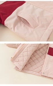 Detail of girls' padded color-block jacket showing quilted lining and side pockets
