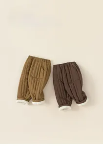 Detail of warm winter kids fleece trousers showing quilted texture and soft lining