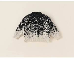 Detailed view of the shaggy knit texture on this black and white gradient kid's sweater
