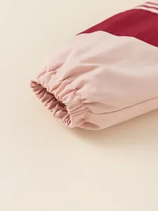 Kids' hooded winter coat with pink and burgundy color-block design and elastic cuffs