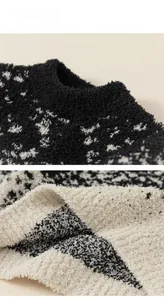 Close-up of black and white fuzzy knit sweater neck with soft textured sherpa fabric