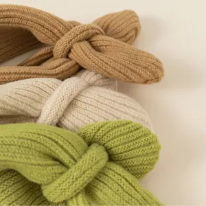 Cozy ribbed knit headbands for children in brown, cream, and green with twist design