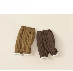 Detail of khaki and brown quilted winter trousers showing warm white fleece lining