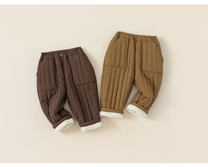 Detail of children's thick quilted winter pants with warm fleece lining and elastic waist