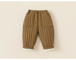 Detail of warm brown quilted winter trousers for kids with soft white fleece lining