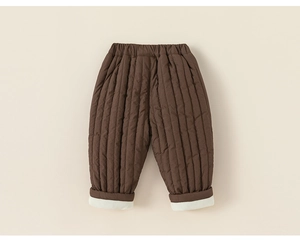 Detail view of quilted kids' winter pants with cozy fleece lining and elastic waist