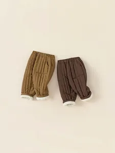 Quilted winter cotton pants for kids in mustard yellow and deep coffee brown