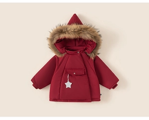Detail of red winter coat featuring a fluffy faux fur hood and white star pendant