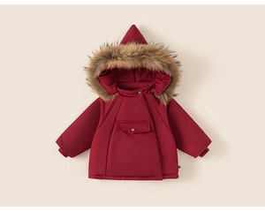 Detailed view of kids hooded winter coat featuring a faux fur collar and deep red windproof fabric