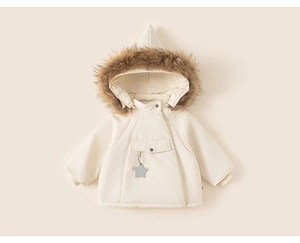 Detail of hooded infant winter coat in cream white with faux fur trim and star tag