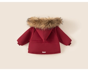 Detail view of red winter coat featuring a thick faux fur hood and adjustable drawstring waist