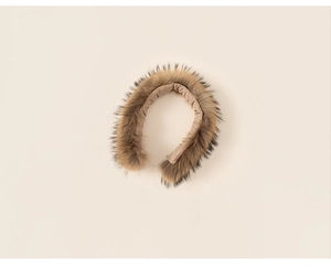 Close-up of premium light brown faux fur hood trim for children's winter jackets