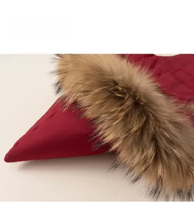 Close-up of vibrant red puffer jacket with high-quality brown faux fur hooded collar details