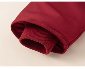 Close-up of red winter coat sleeve with inner elastic ribbed windproof cuffs detail