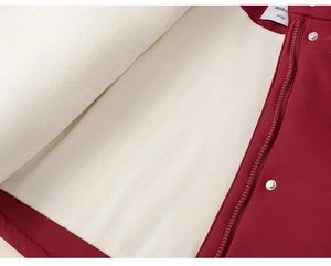Close-up of wine red windproof coat with warm cream fleece lining and silver metal snaps