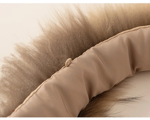 Detail shot of fluffy faux fur hood collar with small button loop on children cotton coat
