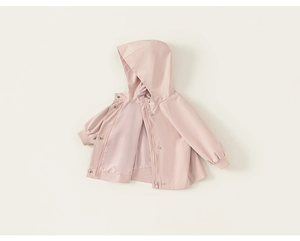 Detail of a pink hooded children's jacket with zipper, snap buttons and elastic cuffs