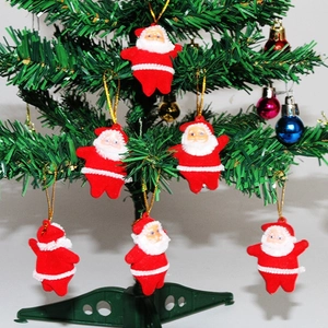 Mini Santa Claus ornaments with gold glitter on a Christmas tree for holiday party decor