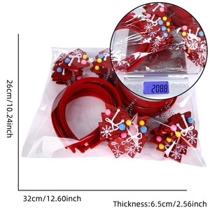 Detailansicht der Weihnachtsbaum-Haarreifen in Verpackung mit Größen- und Gewichtsangaben