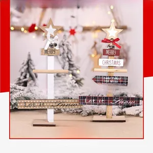 Detail of wooden Christmas tree tabletop decor with layered wood slats and small bells