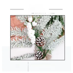 Close-up of frosted Christmas pine needles with cones and burlap base for desk decor
