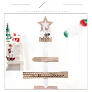 Detail of Nordic wooden Christmas tree with white ribbon bow and rustic metal bells
