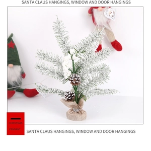 Detail of mini frosted Christmas tree with natural pine cones and burlap base