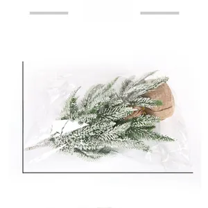 Miniature snow-dusted Christmas tree with burlap base showing 27.5cm height and 40.5cm width
