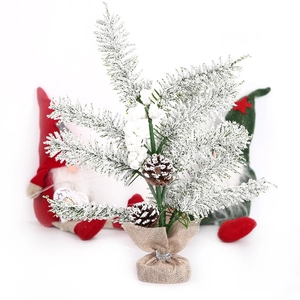 Mini snowy Christmas tree with pine cones and burlap base for desk decor