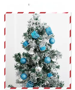 Detail view of mini Christmas tree decorated with blue sequins, silver bells and drums