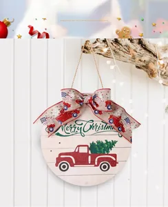 Detail of wooden Merry Christmas door sign with red truck and burlap bow decor