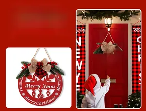 Detail of red wooden Christmas door sign with Merry Xmas cutout and pine needle decor