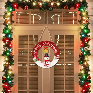 Detail of round Christmas door sign with snowman motif and Merry Christmas lettering
