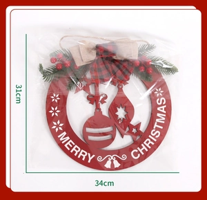 Detailed size view of red wooden Merry Christmas door sign with pine needles and berries
