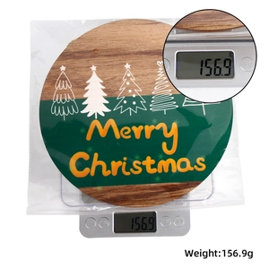 Detailed view of the Christmas wooden sign being weighed showing its weight of 156.9g