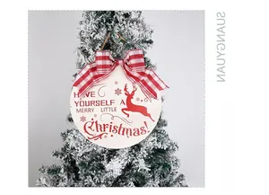 Macro detail of wooden Christmas sign with reindeer print and plaid bow decoration