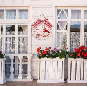 Christmas door sign featuring red reindeer design with festive text and plaid bow detail