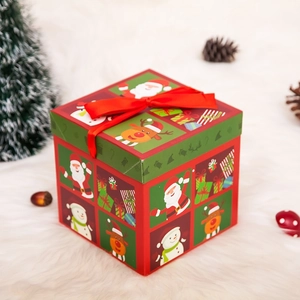Vista detallada de la caja de regalo de Navidad con dibujos de Papá Noel y lazo de satén
