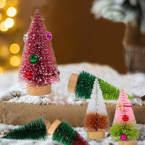 Miniature flocked Christmas cedar trees with colorful baubles and natural wood base