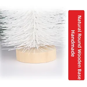 Detail of a mini white frosted Christmas tree featuring a natural round wooden base