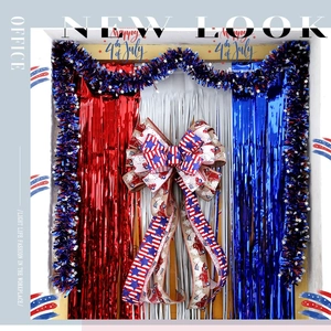 Close-up of 4th of July bow with stars and stripes over red, white and blue tinsel backdrop