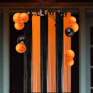 Halloween party set with orange black fringe curtain, letter banner and latex balloons