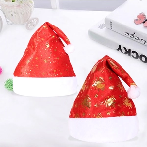 Christmas hats with gold stars and bells, plush red velvet with white pom-poms for holidays