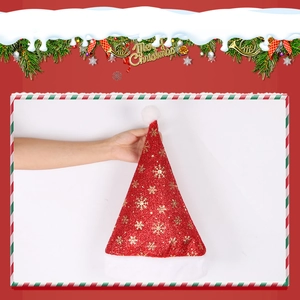 Detail of red sequin Christmas hat with golden snowflakes and plush white trim