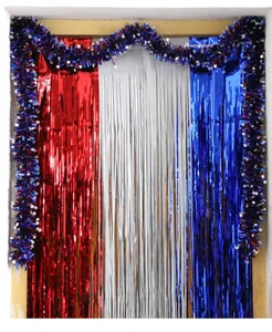 Detail of Fourth of July foil fringe curtains with star tinsel garland party backdrop