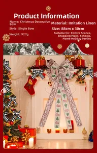 Detail of 88cm large linen Christmas bow with long ribbons hanging on festive fireplace