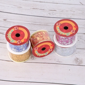 Christmas ribbon set with gold stars and musical notes on five colorful assorted spools